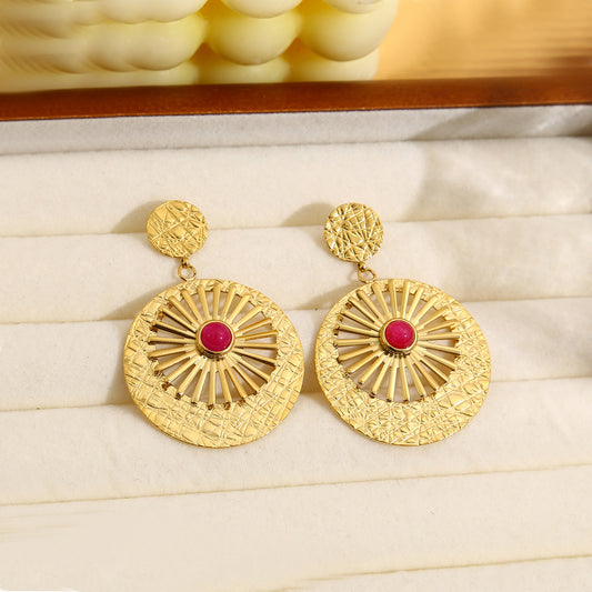 Boucles d'oreilles dorées pendantes avec pierre