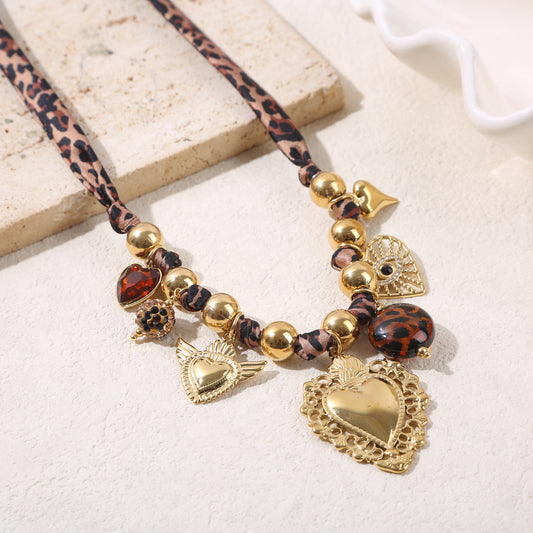Collier billes large dorées orné tissu léopard et charms et grand coeur