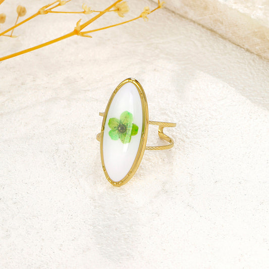 Bague dorée ovale blanche avec fleur verte