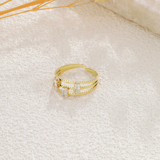Bague dorée ajustable triple branches strass incrustés