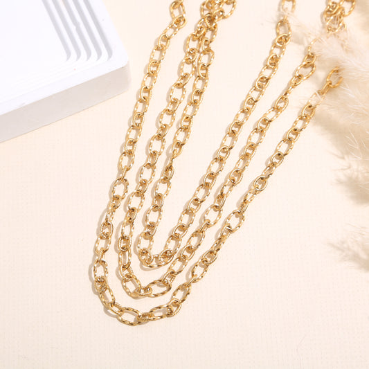 Collier triple chaînes dorées striées