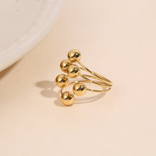 Bague dorée à boules ajustable devant