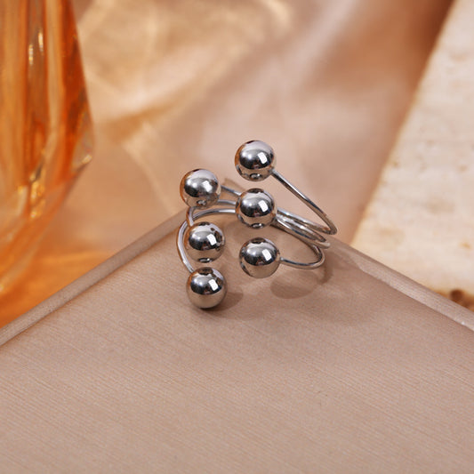 Bague argentée à boules ajustable devant