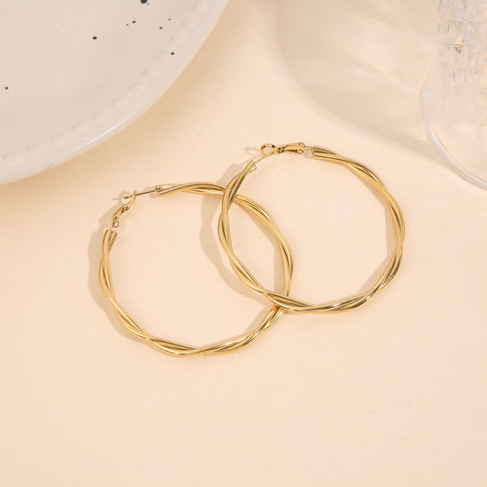 Boucles d'oreilles créoles dorées effet torsadé lisse