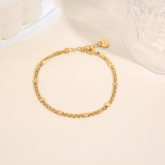 Bracelet chaîne fine double rang dorée maille forçat fine avec pastilles rondes lisses