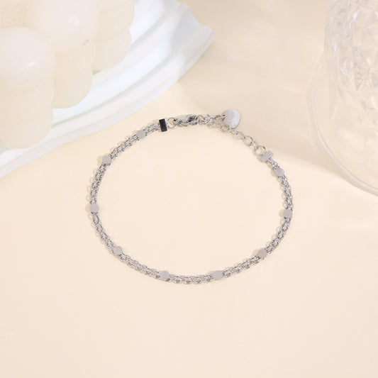 Bracelet chaîne double rang argentée en maille forçat fine avec pastilles rondes lisses