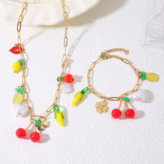 Bracelet chaîne dorée avec breloques fruitées et perle