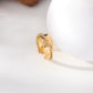 Bague dorée ajustable lisse avec une tresse