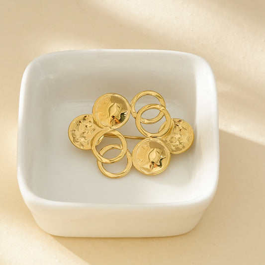 Broche Dorée Multi Disques Et Anneaux Brillants