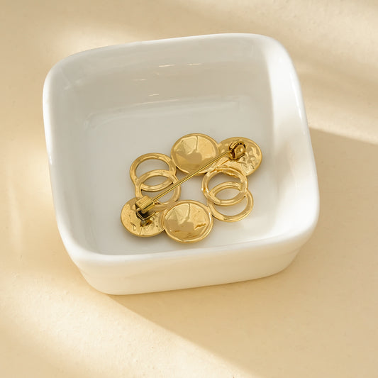 Broche Dorée Multi Disques Et Anneaux Brillants