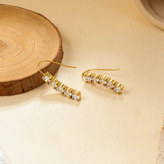 Boucles d'oreilles dorées pendantes ornées de 5 strass ronds alignés