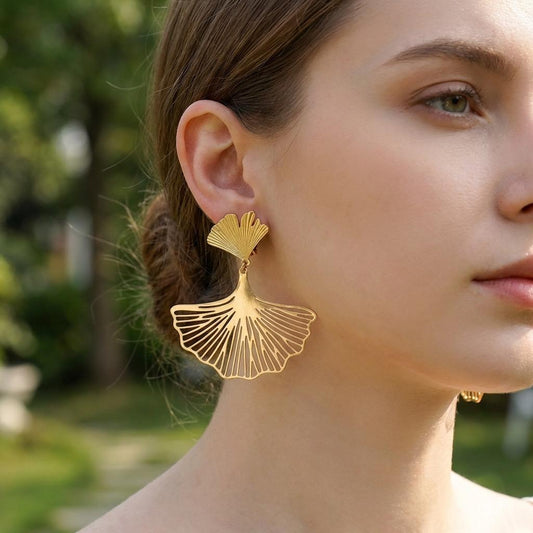 Boucles d’oreilles dorées à clip pendantes feuilles de ginkgo ajourées