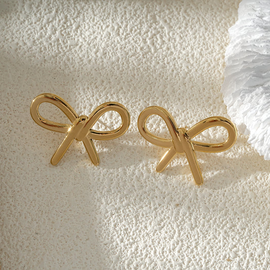 Clous d'Oreilles Dorés Nœud Couture Chic