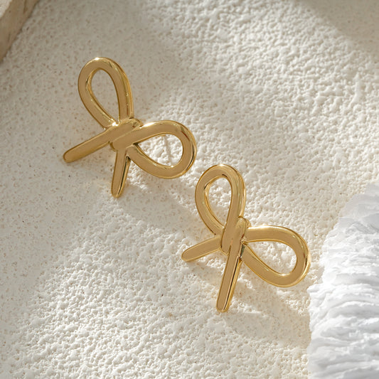 Clous d'Oreilles Dorés Nœud Couture Chic