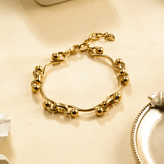 Bracelet Chaîne Dorée Maille Sinueuse et Boule Sphère Effet Brillant