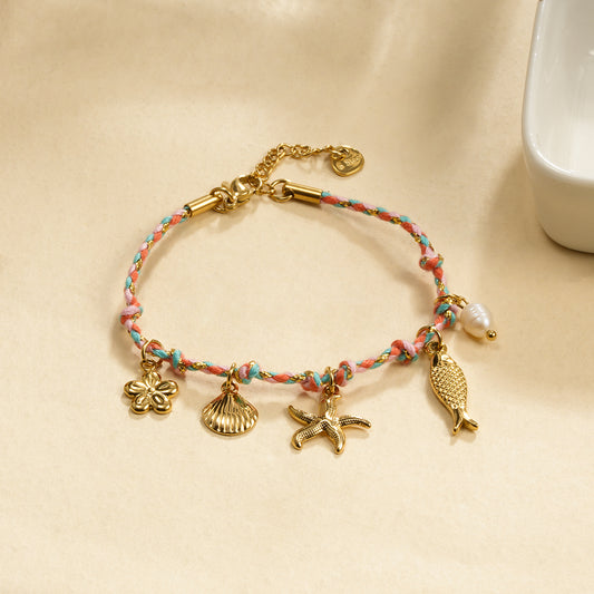Bracelet cordon rose breloques dorés thème de la mer