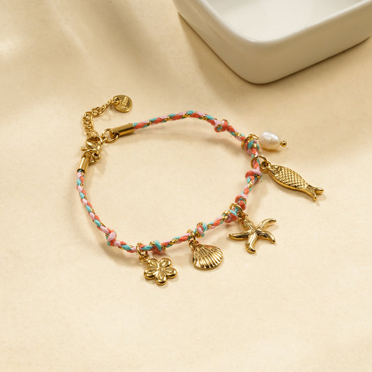Bracelet cordon rose breloques dorés thème de la mer