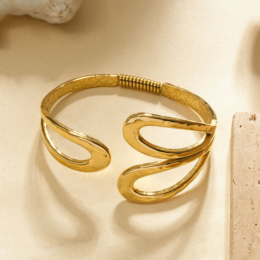 Bracelet jonc doré ouvert à motifs ajourés en forme de gouttes martelées