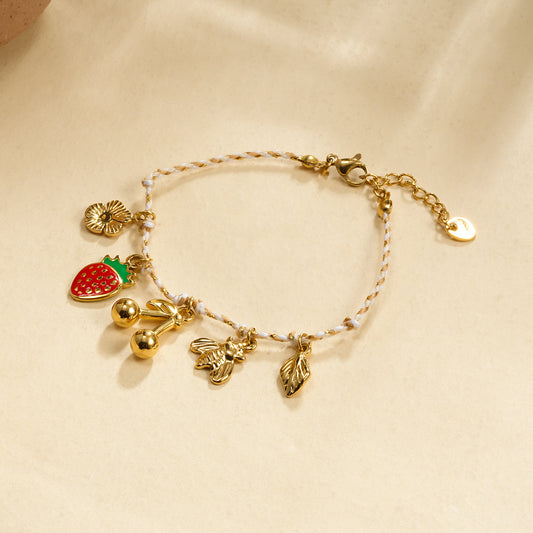 Bracelet cordon breloques cerise abeille et fraise