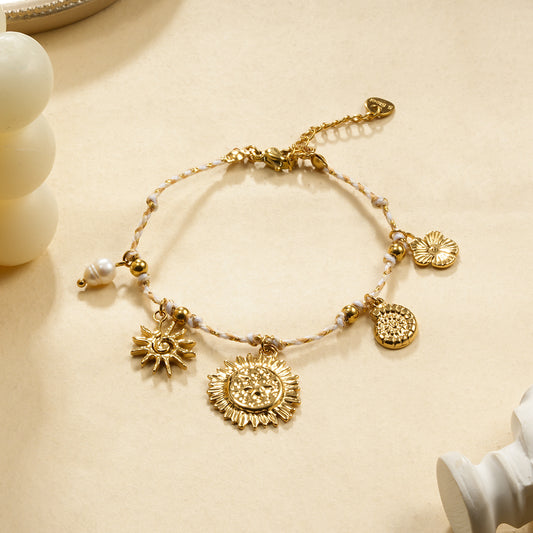 Bracelet cordon beige breloques soleil