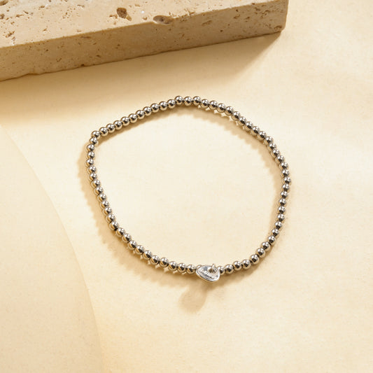 Bracelet élastique argenté billes lisses effet miroir