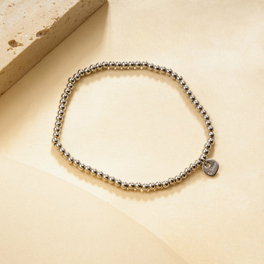 Bracelet élastique argenté billes lisses effet miroir