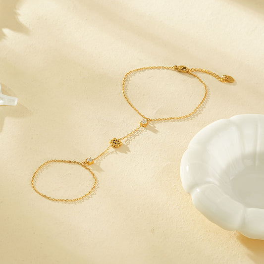 Bracelet chaîne de main dorée fleur 5 pétales et strass carré