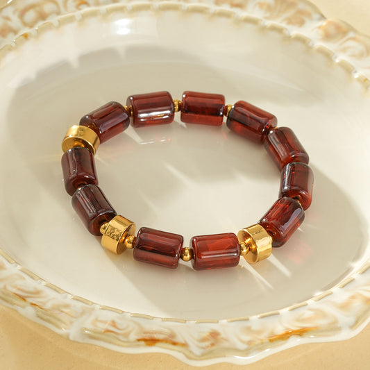 Bracelet élastique résine cylindrique marron ambré anneaux séparateurs dorés