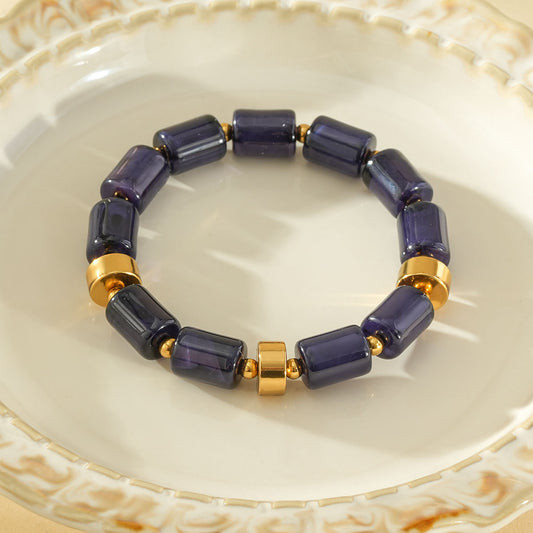 Bracelet élastique résine cylindrique bleu ambré anneaux séparateurs dorés