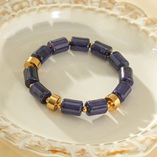 Bracelet élastique résine cylindrique bleu ambré anneaux séparateurs dorés