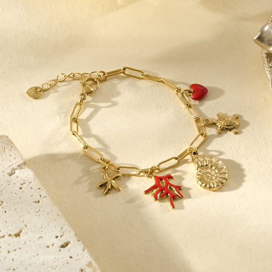 Bracelet doré pendentifs corail rouge, coquillage et cœur
