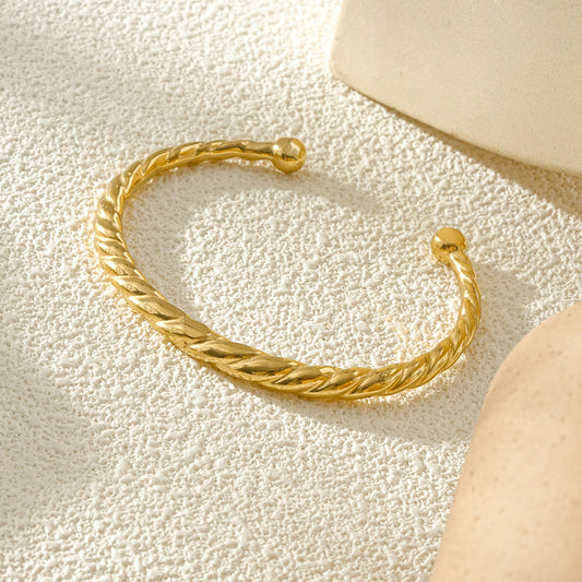 Bracelet jonc ouvert doré torsadé avec embouts boules