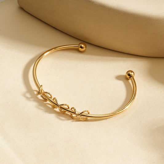 Bracelet manchette dorée ouverte motif nœuds entrelacés