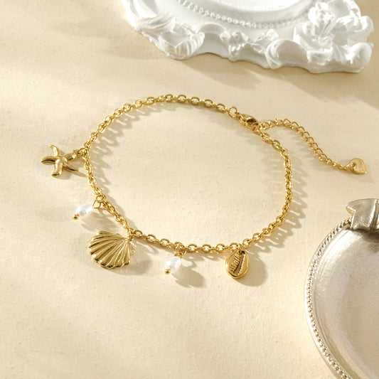 Chaîne de cheville dorée coquillage, cauri et perles