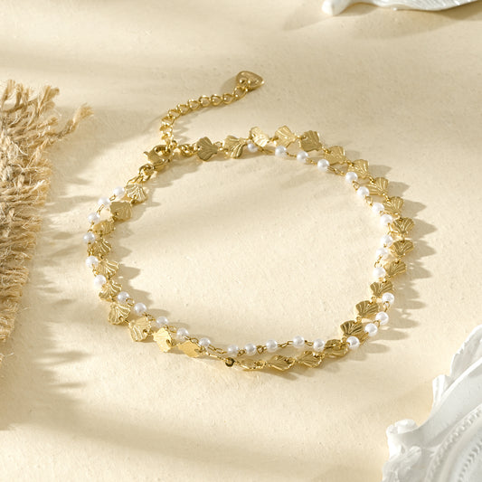 Chaîne de cheville dorée double rang avec coquillages pavées