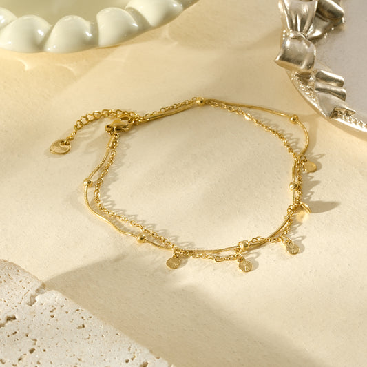 Chaîne de cheville dorée minimaliste à médailles