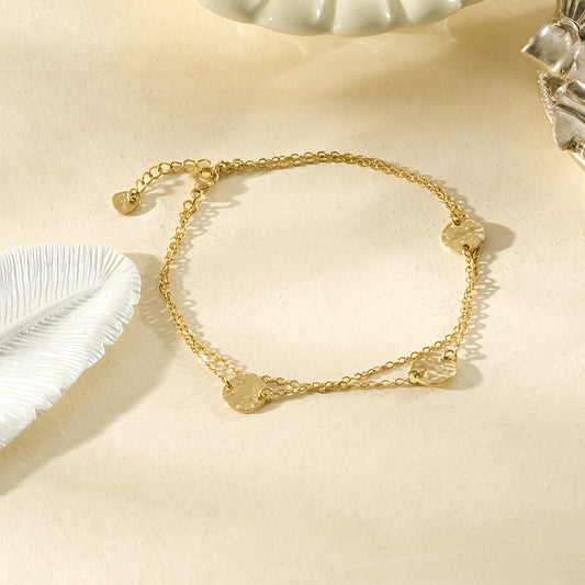 Chaîne de cheville dorée de trois plaques rondes martelées