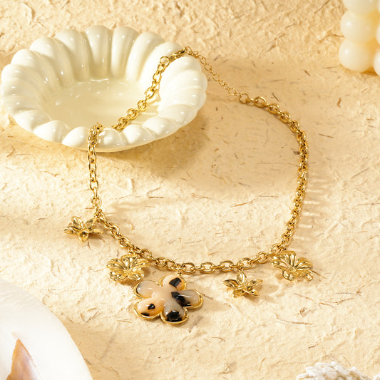 Collier chaîne dorée breloques avec fleur résiné léopard