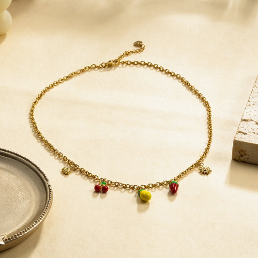Collier chaîne dorée breloques fruits et soleil