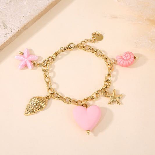 Bracelet doré breloques mer colorée rose
