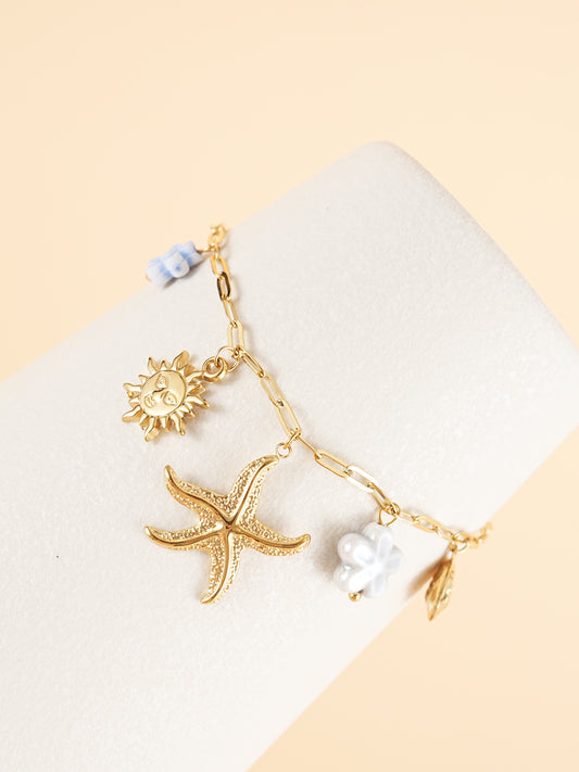 Bracelet chaîne dorée breloques de la mer et fleurs