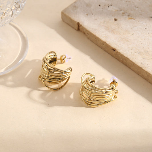 Boucles d’oreilles dorées larges torsadées multi-anneaux effet texturé