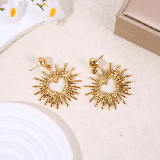 Boucles d’oreilles dorées pendantes cœur rayonnant