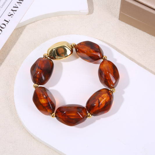 Bracelet élastique doré résine marron translucide marbrée formes arrondies