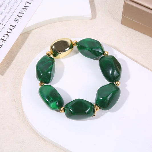 Bracelet élastique doré résine verte marbrée formes arrondies