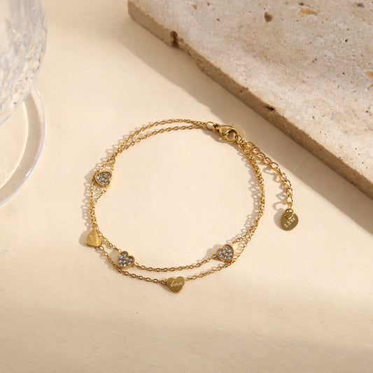 Bracelet doré double chaîne fine avec pampilles cœurs lisses gravés "love" ou strassés