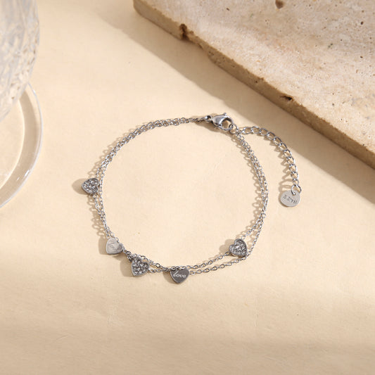 Bracelet argenté double chaîne fine avec pampilles cœurs lisses gravés "love" ou strassés