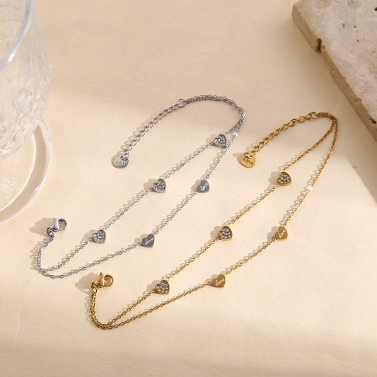 Bracelet argenté double chaîne fine avec pampilles cœurs lisses gravés "love" ou strassés