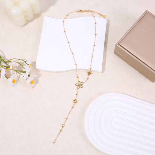 Collier doré en Y à fleurs ajourées et petites billes