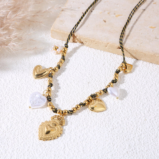 Collier cordon noir perles dorées et pampilles cœurs dorés et nacrés, pendentif ex-voto central